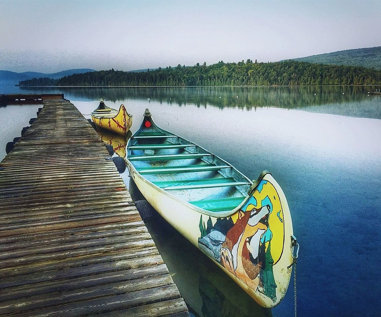 Wooden dock stretching into calm lake waters
